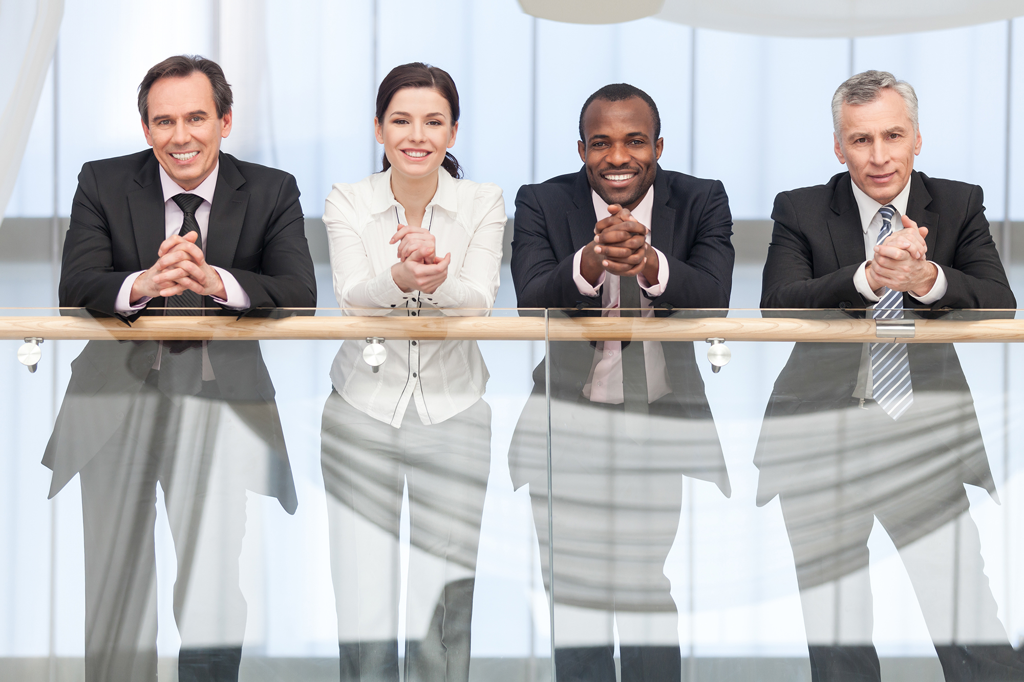 Group,Of,Business,People,Smiling,On,Camera