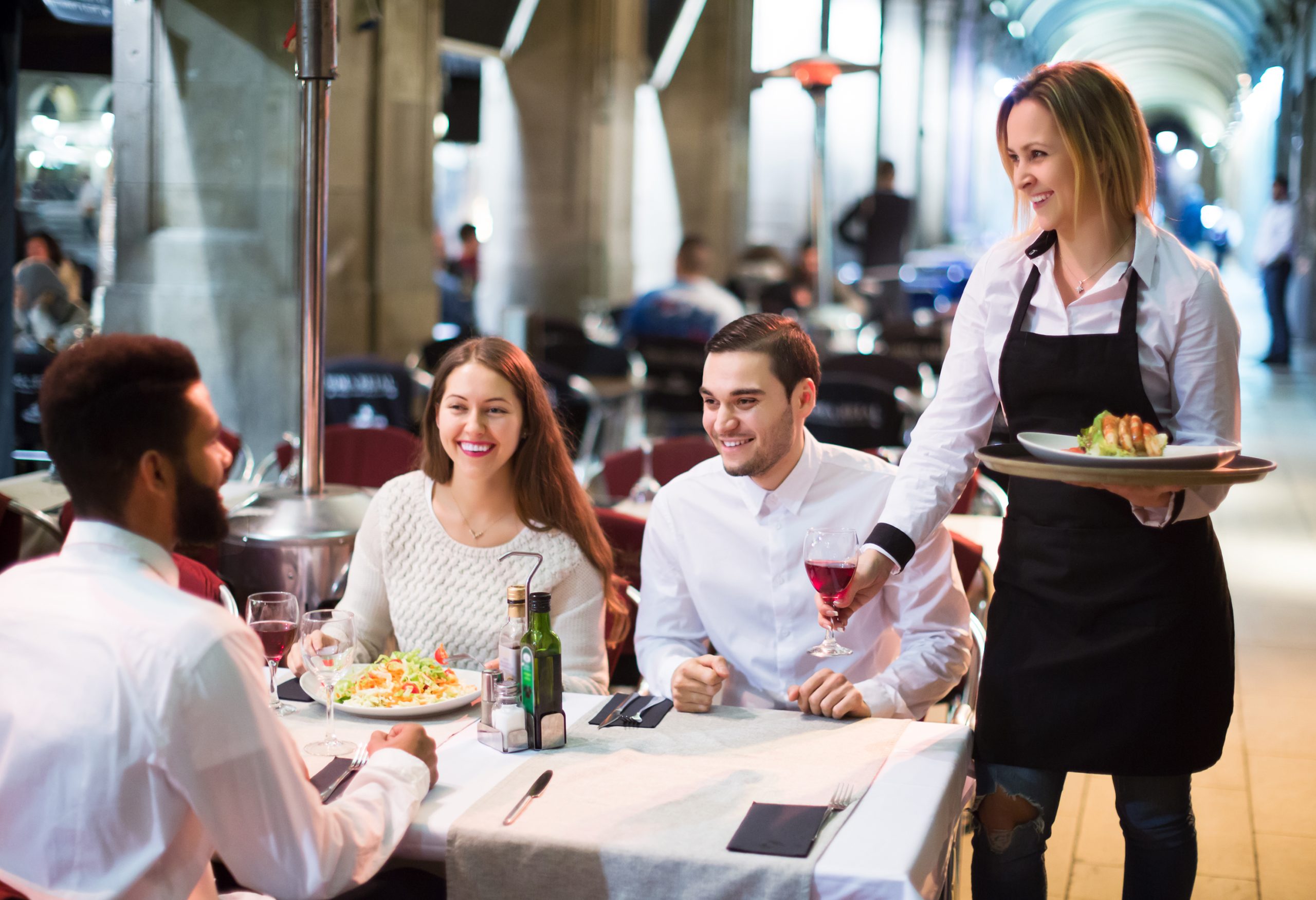 Portrait,Of,Smiling,Adult,Friends,In,Outdoors,Restaurant,And,Smiling